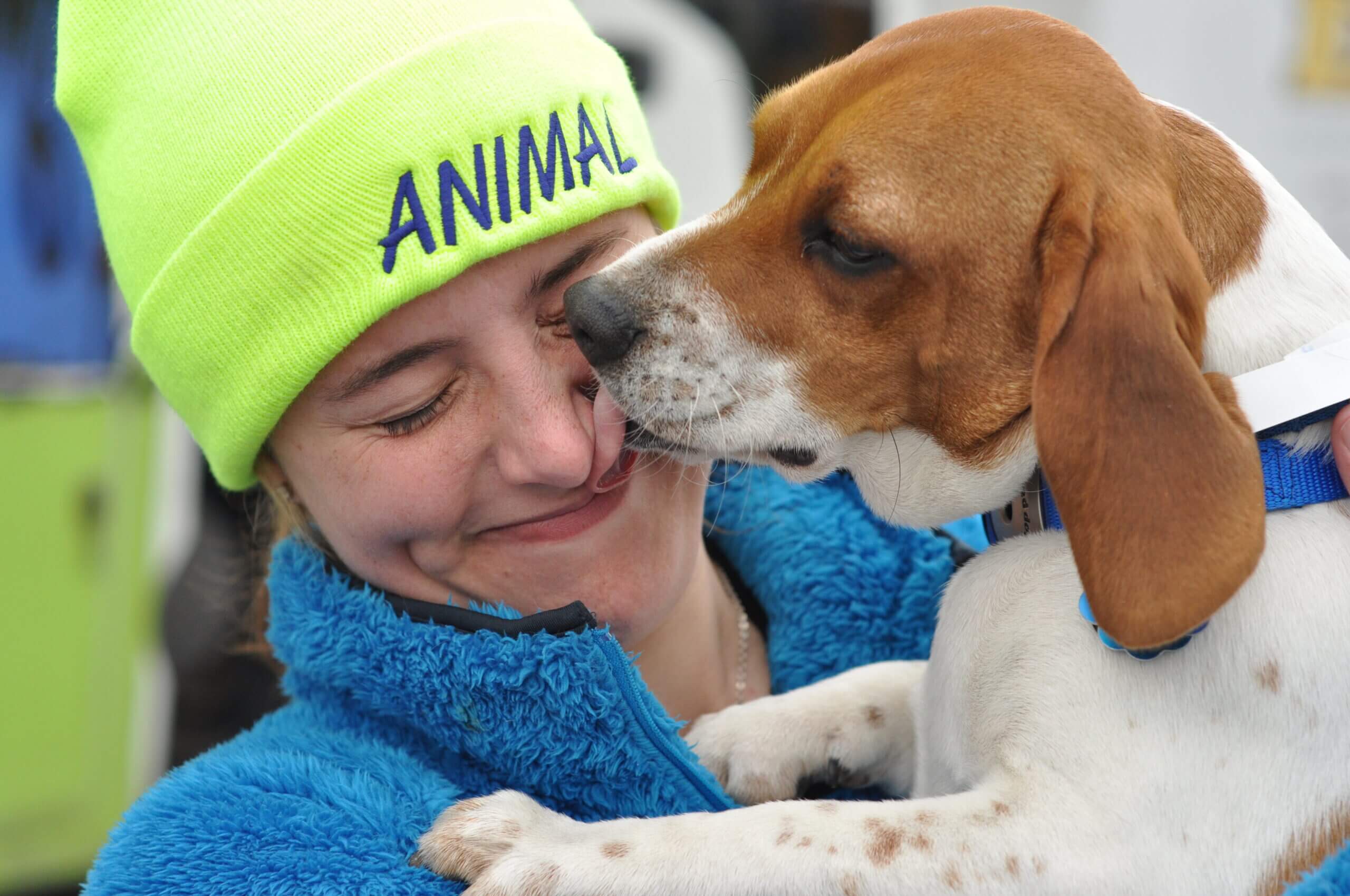 Lady with dog licking her face